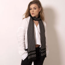 Load image into Gallery viewer, ärtskül’s playful and polished Baby Pop, Nana Rectangle scarf is high style with minimal effort. Luxuriously soft, this eye-catching scarf with our baby icon features a contemporary reinterpretation of the distinctive houndstooth motif in black and white. The scarf drapes elegantly and can complement any look from casual to black tie. Lightweight and warming, this classic black and white scarf amps up the glamour for those that don’t want to blend in.