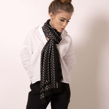 Load image into Gallery viewer, Finish your look with ärtskül’s luxuriously soft Baby Pop, Nana Rectangle scarf. This black and white cashmere blend scarf is artfully manufactured by master Italian craftsman and designed in Los Angeles. Lightweight and warming, the scarf features our contemporary reinterpretation of the distinctive houndstooth motif.  The striking geometric repetition of the baby icon produces a chic re-imagining of the centuries old Scottish mosaic.