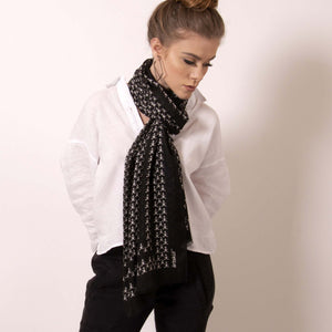 Finish your look with ärtskül’s luxuriously soft Baby Pop, Nana Rectangle scarf. This black and white cashmere blend scarf is artfully manufactured by master Italian craftsman and designed in Los Angeles. Lightweight and warming, the scarf features our contemporary reinterpretation of the distinctive houndstooth motif.  The striking geometric repetition of the baby icon produces a chic re-imagining of the centuries old Scottish mosaic.  