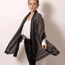 Load image into Gallery viewer,   Swing between delicate and fierce with ärtskül’s Baby Pop, Nana Rectangle scarf. This luxurious cashmere blend scarf in black and white is lightweight yet warming.  The scarf drapes beautifully with billowy elegance featuring our contemporary reinterpretation of the distinctive houndstooth motif.  The striking geometric repetition of the baby icon produces a chic re-imagining of the centuries old Scottish mosaic.  