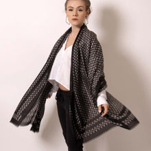 Load image into Gallery viewer,   Swing between delicate and fierce with ärtskül’s Baby Pop, Nana Rectangle scarf. This luxurious cashmere blend scarf in black and white is lightweight yet warming.  The scarf drapes beautifully with billowy elegance featuring our contemporary reinterpretation of the distinctive houndstooth motif.  The striking geometric repetition of the baby icon produces a chic re-imagining of the centuries old Scottish mosaic.