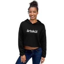 Load image into Gallery viewer, Artskul's black cropped hoodie with a white artskul logo. This hoodie is as comfortable as it is stylish. This hoodie has a drop shoulder cut and features a trendy raw hem and matching drawstring. The soft and cozy hoodie is likely to become your favorite go-to piece whether on the street, out for a hike, or lounging on the couch.