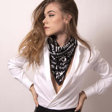 Load image into Gallery viewer, Artskul's chic black and white logo scarf is styled as a neck scarf. Elevate your style with luxury street style edge.