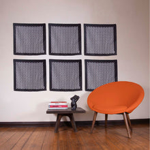 Load image into Gallery viewer, artskul's baby pop inc pocket square as wall decor with a pumpkin chair and art books by Magritte, Vogue, Moroni and Michelangelo with a resin torso sculpture and custom designed and fabricated occasional table by the artist Brian Biedul.