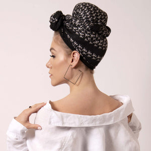 Make a statement and transform ärtskül’s iconic black and white Baby Pop, Nana Rectangle scarf into a chic turban. Express your personality and style with a few creative ties and twists that can make a challenging hair day a thing of the past. The scarf features the reimagined houndstooth pattern with the baby icon. Adds a nice touch of attitude to any outfit.