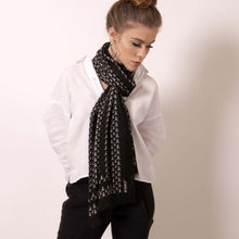 Load image into Gallery viewer, Finish your look with ärtskül’s luxuriously soft Baby Pop, Nana Rectangle scarf. This black and white cashmere blend scarf is artfully manufactured by master Italian craftsman and designed in Los Angeles. Lightweight and warming, the scarf features our contemporary reinterpretation of the distinctive houndstooth motif.  The striking geometric repetition of the baby icon produces a chic re-imagining of the centuries old Scottish mosaic.  