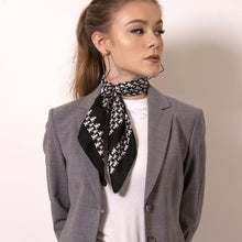 Load image into Gallery viewer, Artskul&#39;s Baby Pop Nana Scarf in silk twill is irresistibly chic in  black and white. Shift your image from frivolous fashionista to polished professional with a creative edge. The scarf features the remixed houndstooth pattern with the baby icon and adds a signature look to a crisp white fitted shirt. 