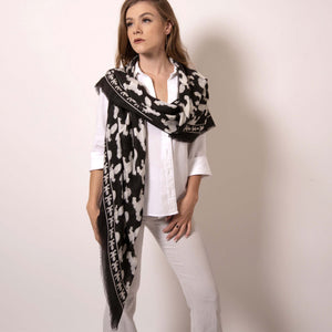 With a simple drape of this cashmere blend scarf, it's what a goddess truly looks like. Wrap yourself in luxury with this Artskul Baby Pop Square scarf featuring our reimagined houndstooth pattern with the baby icon from the fine art series Baby Pop, Inc. Artskul's remixed pattern in black and white is a chic reimagining of the centuries old Scottish Mosaic.  Soft, lightweight and warming - you won't want to be without it.