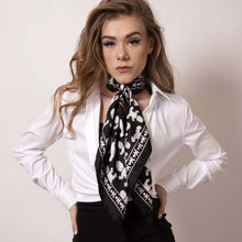 Load image into Gallery viewer, Rock both sexy and classic looks at work with ärtskül&#39;s Baby Pop Square Scarf. The black and white scarf adds a touch of edgy sophistication to a crisp white shirt. ärtskül’s remixed houndstooth pattern captivates the eye while paying homage to the classic print with a twist of the unexpected. Channel your inner boss baby! 