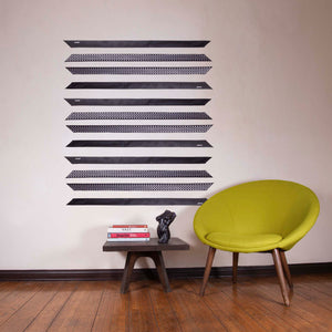 ärtskül's Baby Pop Ribbon Scarf is featured as wall decor. The Ribbon scarf creates an interesting design on your wall and when you are ready to visually reinvent your space, gift your favorite friends a scarf with love. The energy of your living space with something meaningful in your home is a great gift to share with the people you love in your circle of friends. Also featured in the image is a torso resin sculpture and custom occasional table by the artist Brian Biedul.