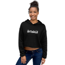 Load image into Gallery viewer, Artskul&#39;s black cropped hoodie with a white artskul logo. This hoodie is as comfortable as it is stylish. This hoodie has a drop shoulder cut and features a trendy raw hem and matching drawstring. The soft and cozy hoodie is likely to become your favorite go-to piece whether on the street, out for a hike, or lounging on the couch.