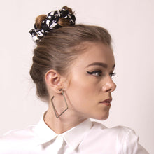 Load image into Gallery viewer,  You can tell a lot about someone from the bun they choose to wear. artskul&#39;s chic black and white logo scarf can transform your throw-up-and-go hairstyle into a polished statement about what your bun says about you.
